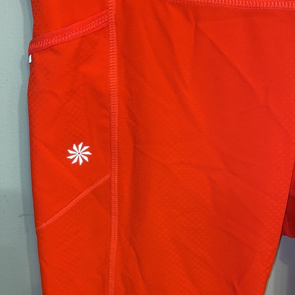 Athleta NWOT orange, thin leggings with side pockets, zip packet size Medium - Picture 3 of 7